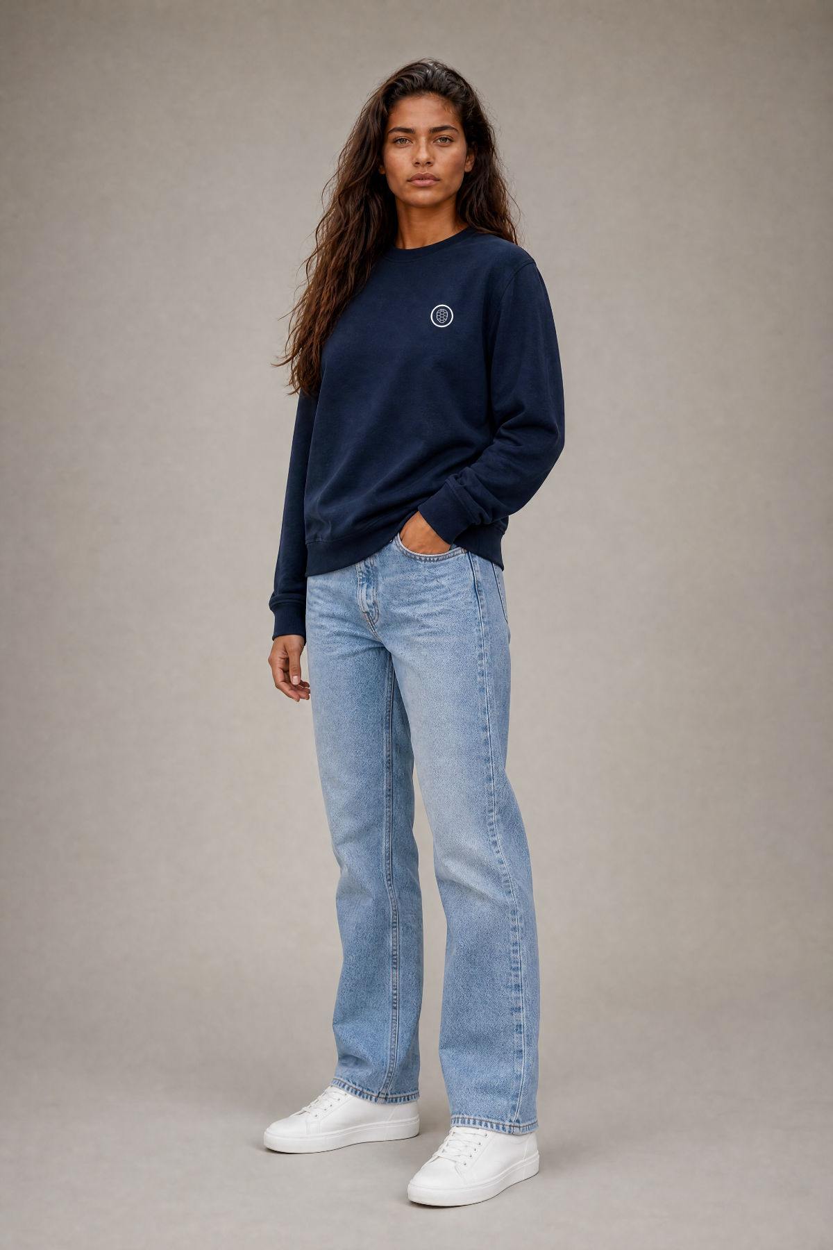Woman in navy ONETURTLE sweatshirt and light jeans, studio photo